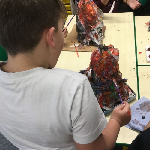 Painting our paper mache volcanoes we built last week! 