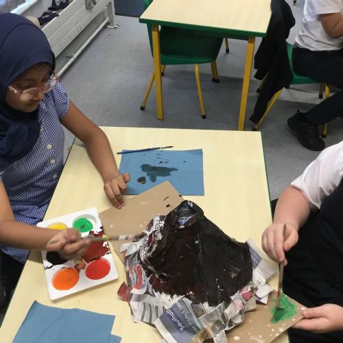 Painting our paper mache volcanoes we built last week! 