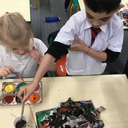 Painting our paper mache volcanoes we built last week! 