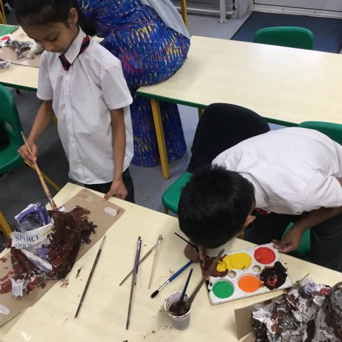 Painting our paper mache volcanoes we built last week! 
