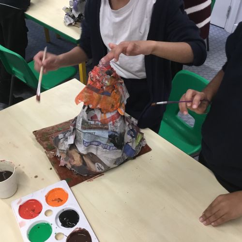Painting our paper mache volcanoes we built last week! 