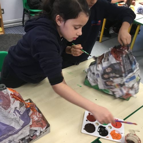 Painting our paper mache volcanoes we built last week! 