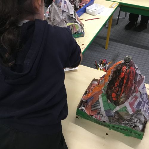 Painting our paper mache volcanoes we built last week! 