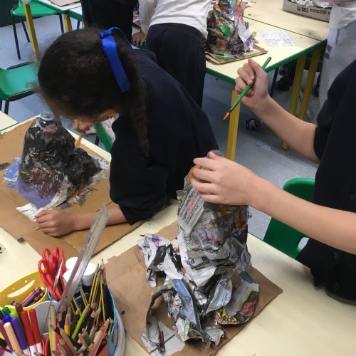 Painting our paper mache volcanoes we built last week! 
