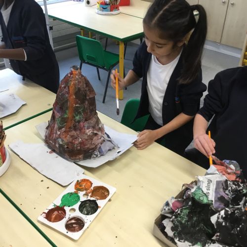 Painting our paper mache volcanoes we built last week! 